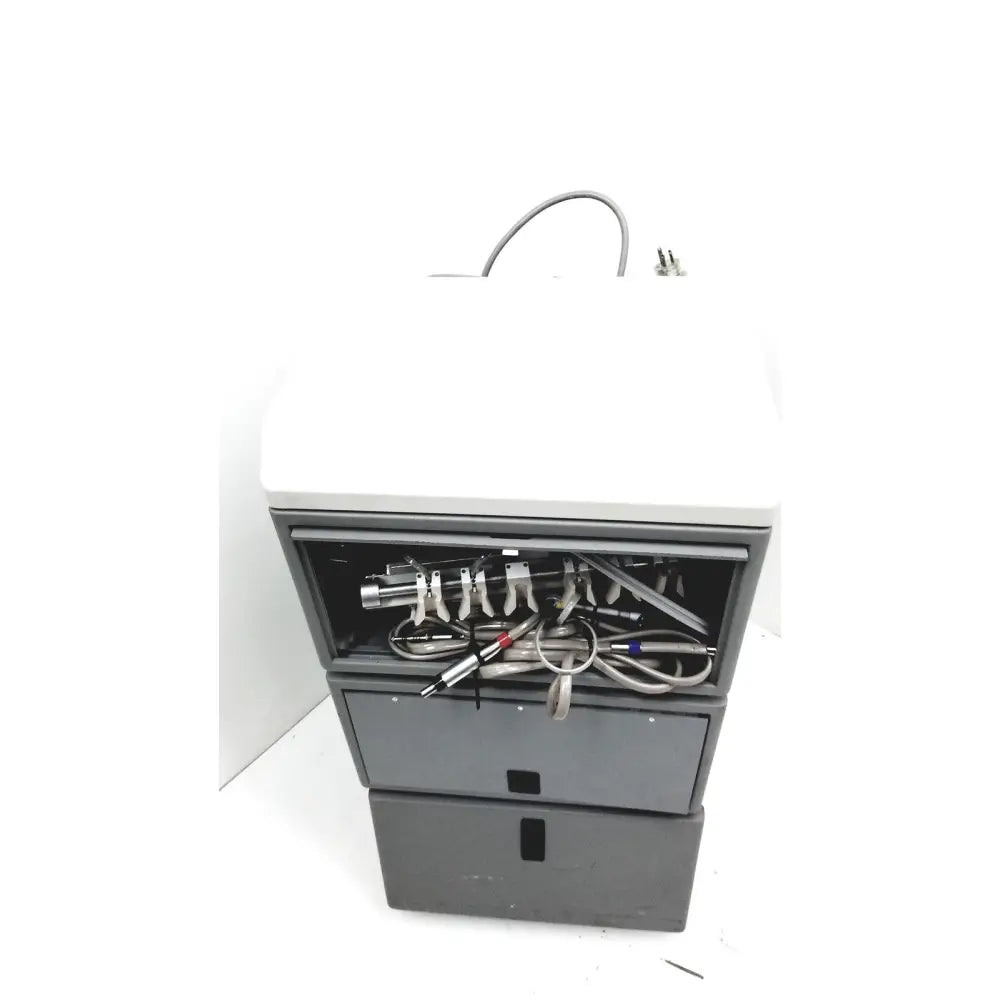 Gray and white dntl works p-2000 dental delivery unit showing open front compartment with tubes and metallic connectors inside