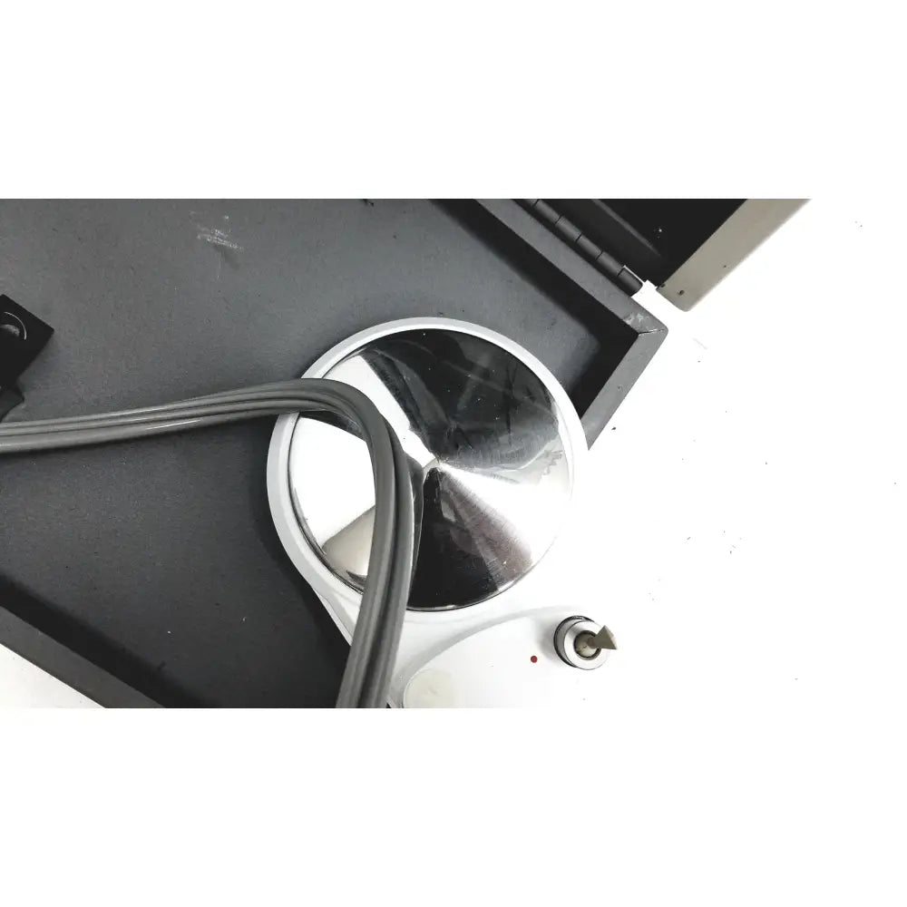 Dntl works p-2000 dental delivery unit with a silver circular heating plate and smooth reflective surface on white base