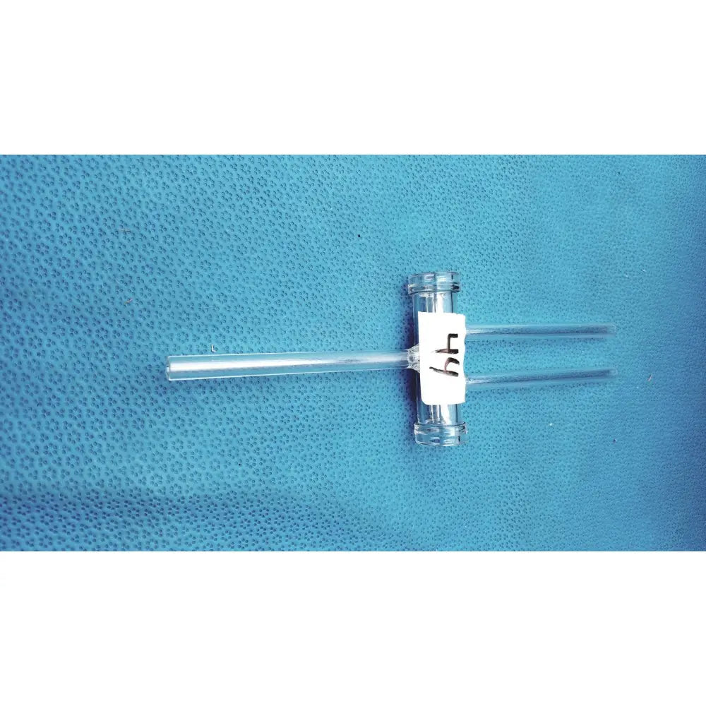 Clear glass t-shaped double oblique bore glass stopcock with white label 64 made of borosilicate for precision control