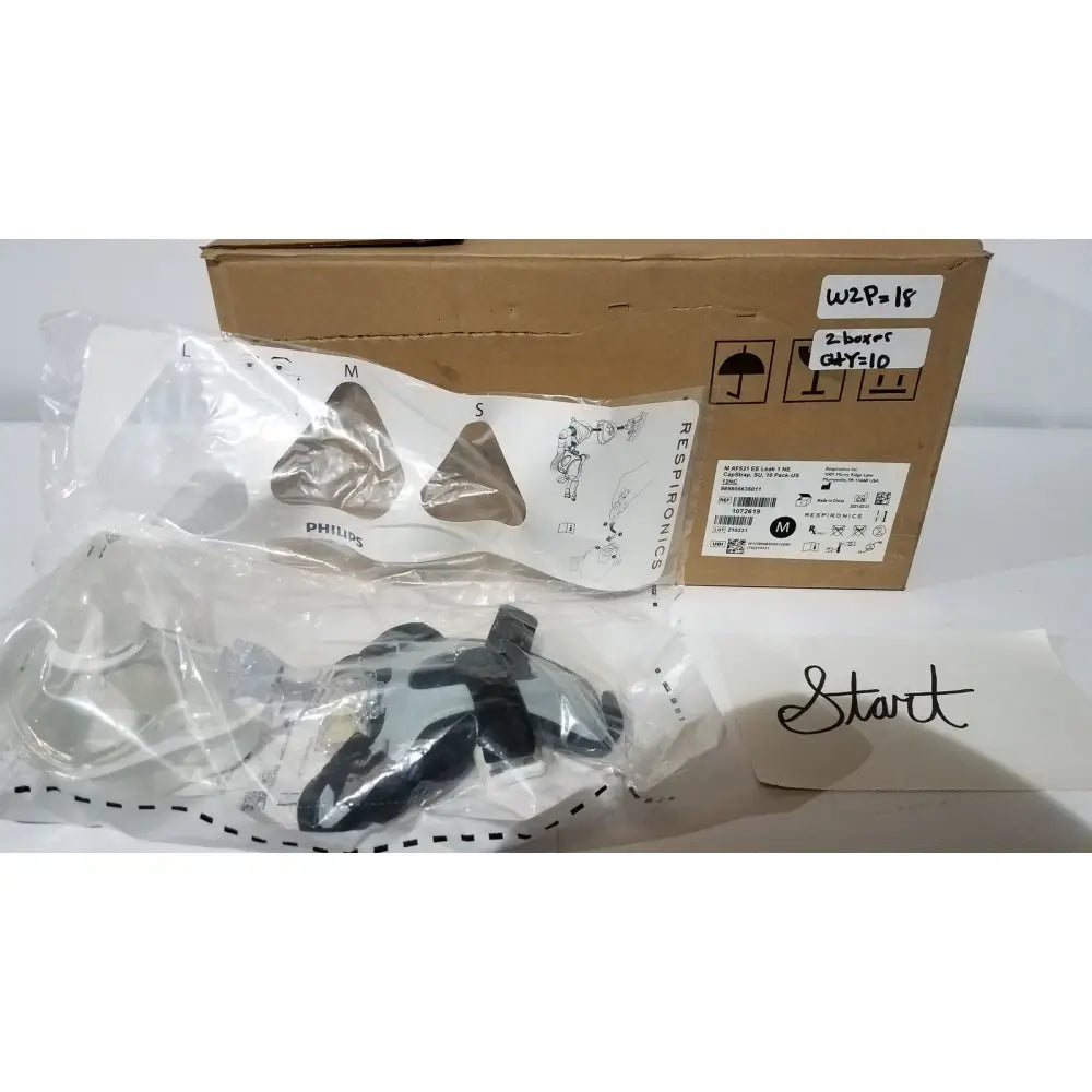 Philips respironics cpap mask with clear plastic frame and black straps in transparent bag for home bed assist use