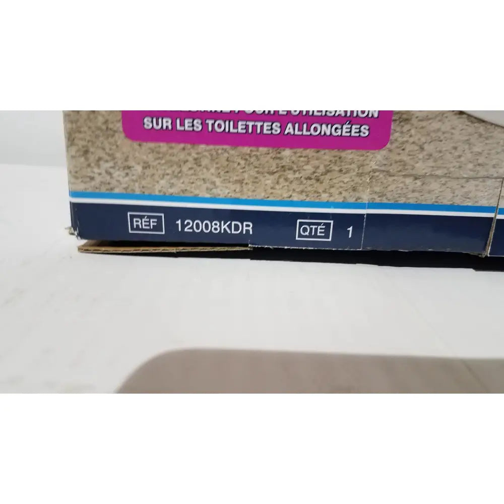 A beige textured cardboard box with pink label and blue stripe for drive raised toilet seat 5 inch height model rtl12027ra