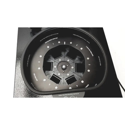 Black circular wheel balancing machine with numbered slots and silver bolts for drucker diagnostics dash apex 24 centrifuge