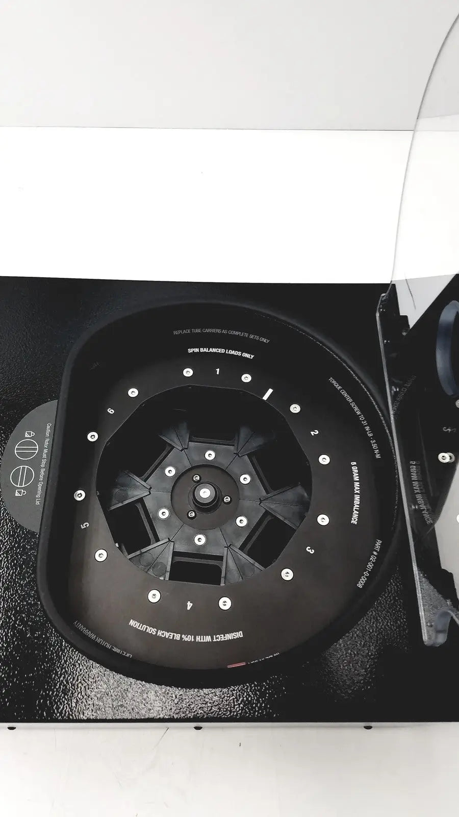 Black laboratory centrifuge with numbered slots and white labeling for fast sample processing drucker diagnostics dash apex