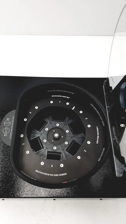 Black laboratory centrifuge with numbered slots and white labeling for fast sample processing drucker diagnostics dash apex