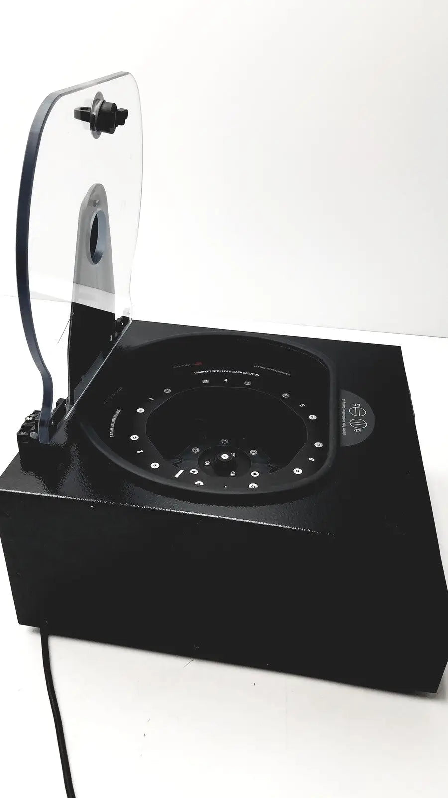 Black rectangular drucker diagnostics dash apex 24 centrifuge with transparent hinged lid and circular interior with white dots