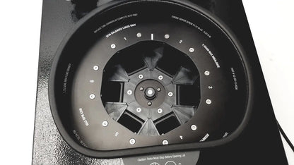 Black circular wheel balancing machine with numbered slots and silver bolts for drucker diagnostics dash apex 24 centrifuge