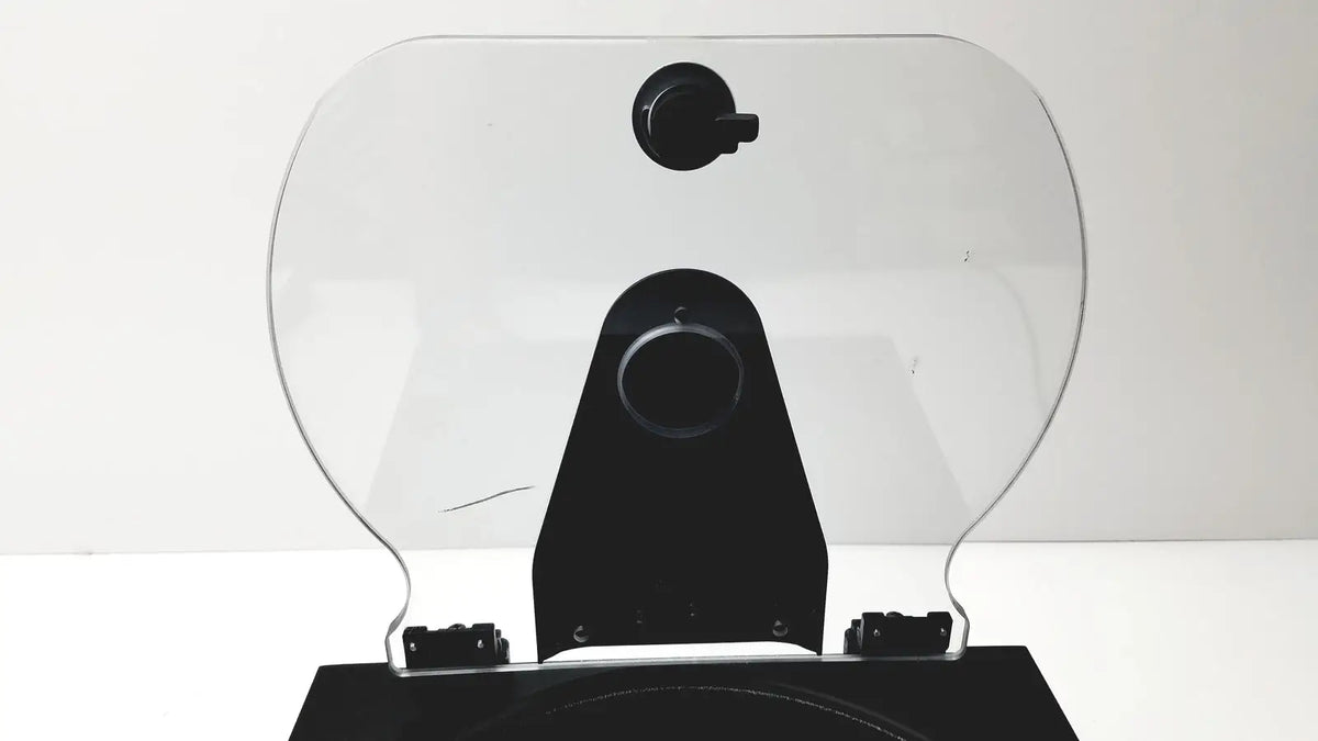 Clear plastic motorcycle windshield with black mounting bracket and adjustment knobs on drucker diagnostics dash apex 24 centrifuge