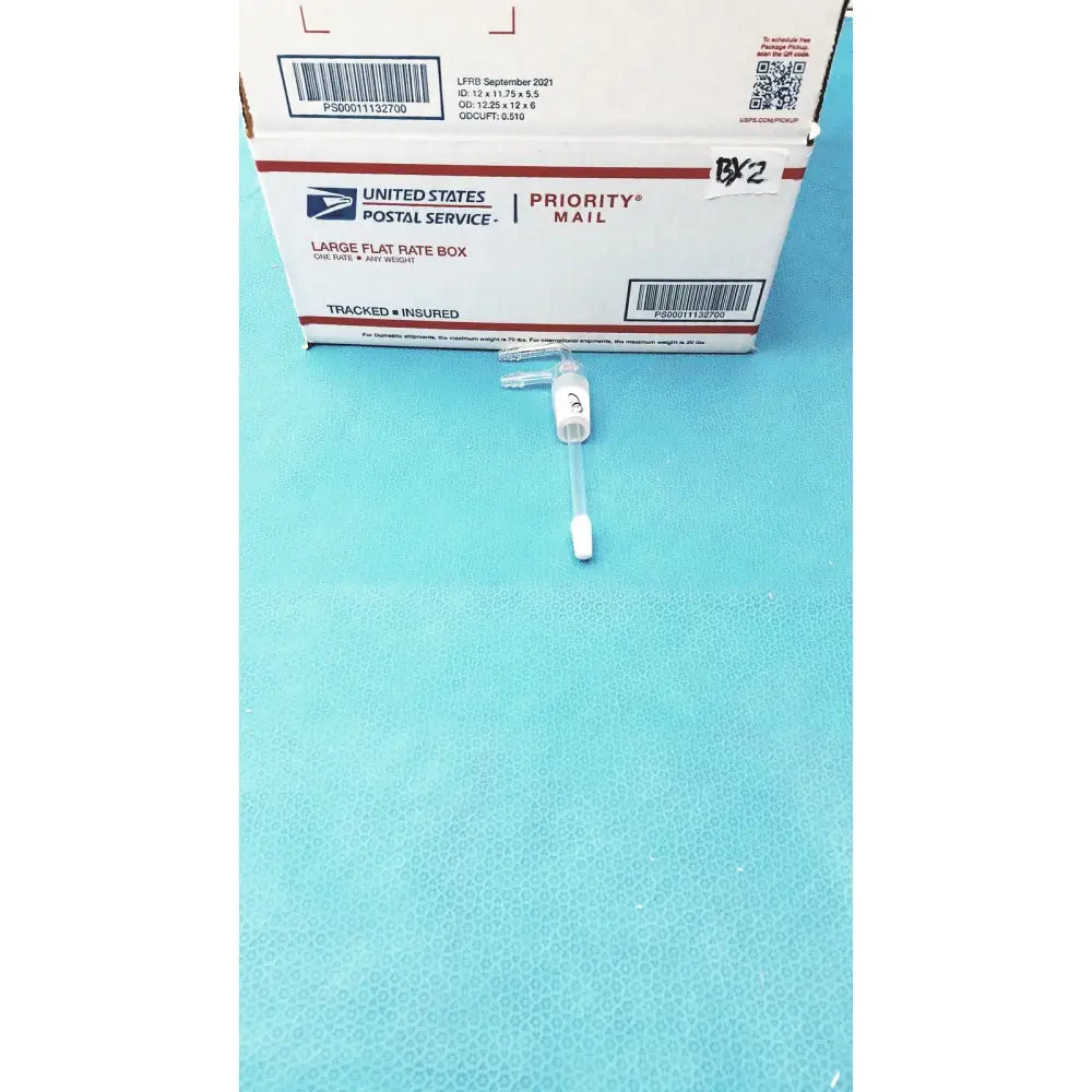 White plastic medical syringe with clear barrel and needle cap for dual port gas inlet adapter use