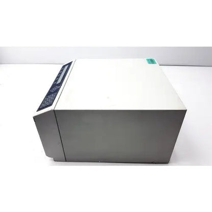 Gray rectangular dynatech mrx microplate reader with black control panel and green label for laboratory use