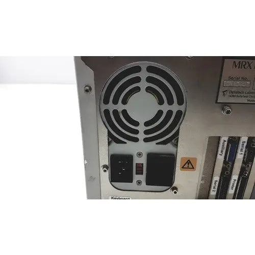 Silver metallic dynatech mrx microplate computer tower with circular vent power and reset buttons labeled expansion slots