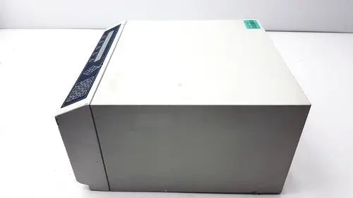 Gray rectangular dynatech mrx microplate reader with black control panel and green label for laboratory use