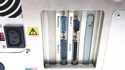 Back panel of dynatech mrx microplate reader showing blue db-9 serial and auxiliary ports on metallic housing