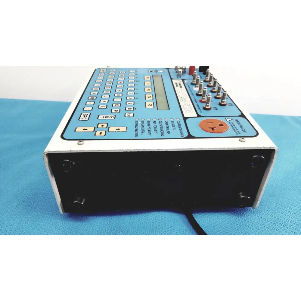 Dynatech nevada medtester 5000 biomedical electrical safety analyzer with white and blue casing, keypad, display, and orange power plug