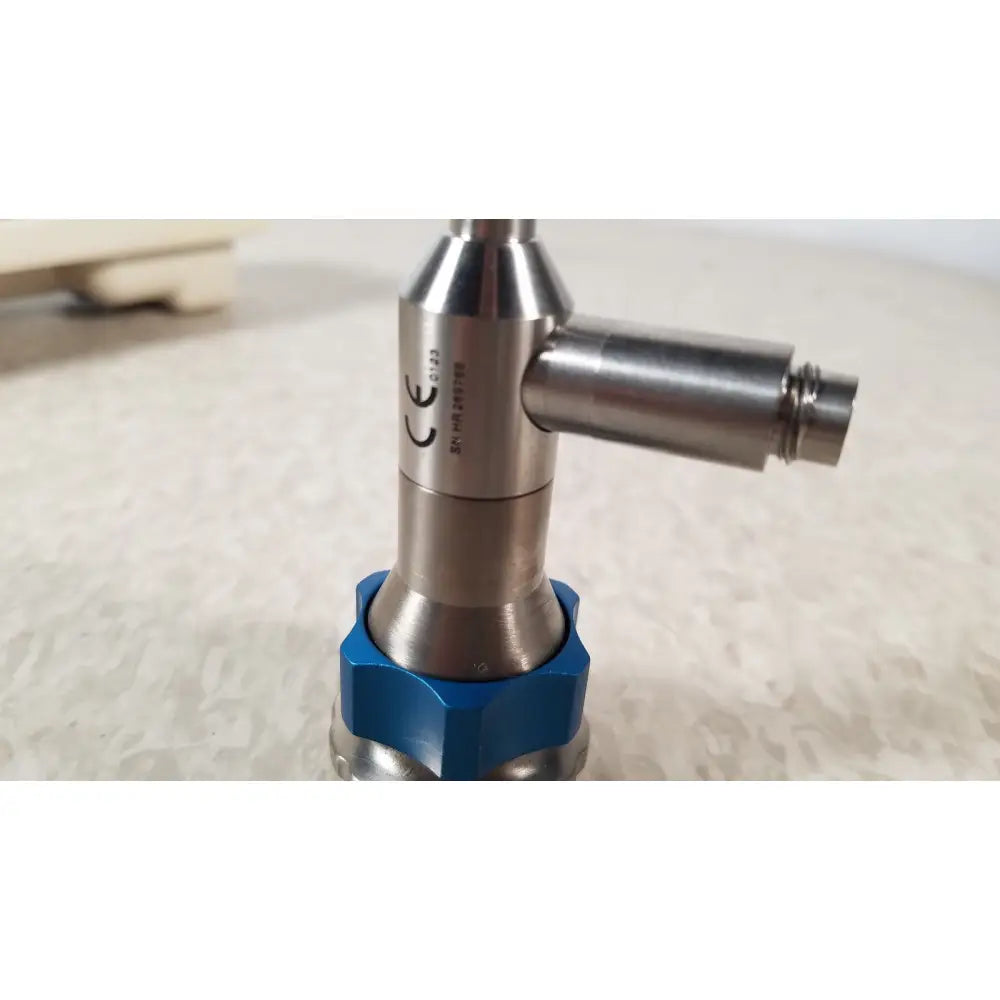 Silver metallic industrial valve dyonics 30 degree sn hr 268768 with blue hexagonal base and reuse medical certification markings