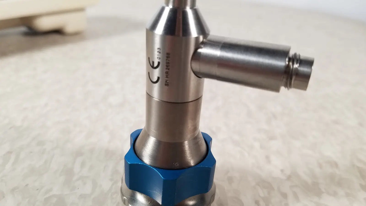 Silver metallic industrial valve dyonics 30 degree sn hr 268768 with blue hexagonal base and reuse medical certification markings