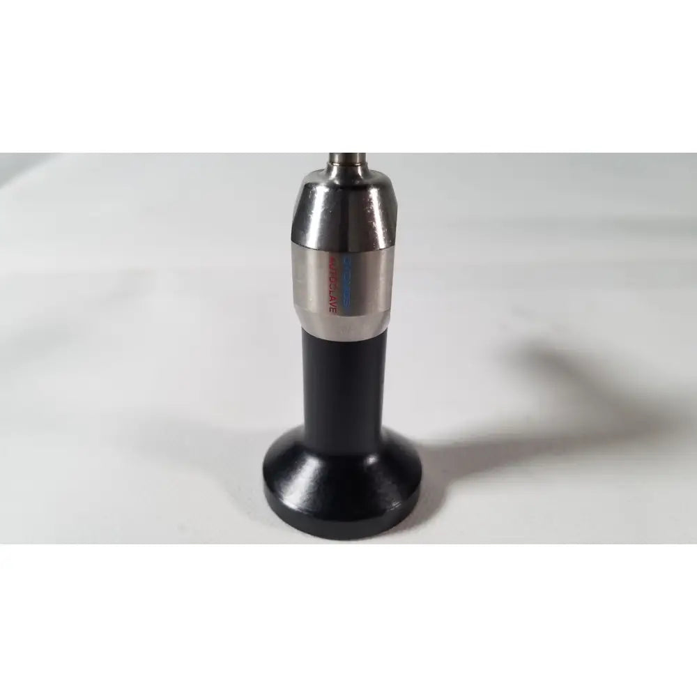 Black and silver dyonics 7207951 degree autoclavable laparoscope with cylindrical body and engraved metallic top section