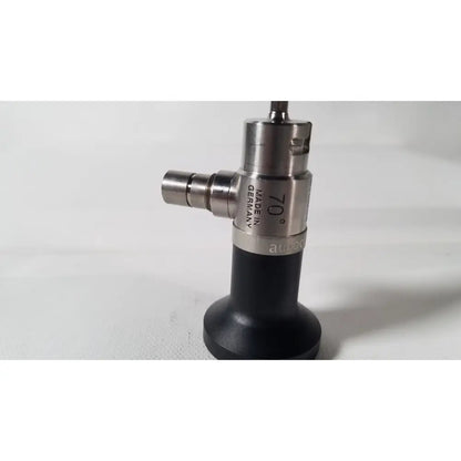 Silver and black dyonics autoclavable 4mm 70 degree arthroscope with angled tip marked made in germany on metallic body