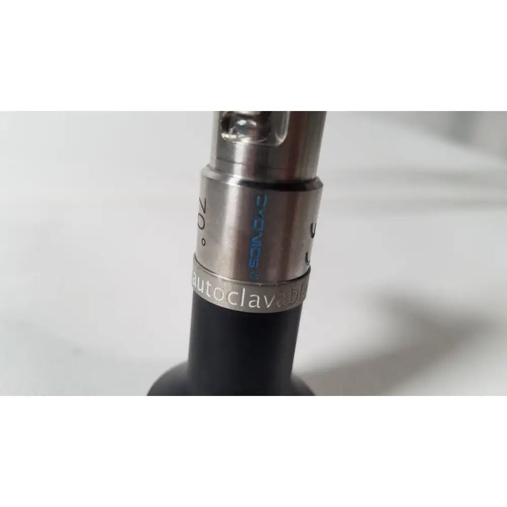 Silver metallic threaded connector engraved autoclavable d-vacs 30° attached to black body of dyonics autoclavable 4mm arthroscope