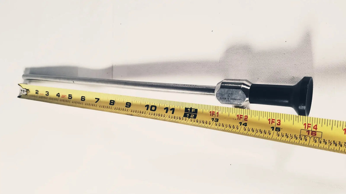 Silver medical dyonics autoclave degree 10mm laparoscope with black ergonomic handle and metallic joints shown with measuring tape