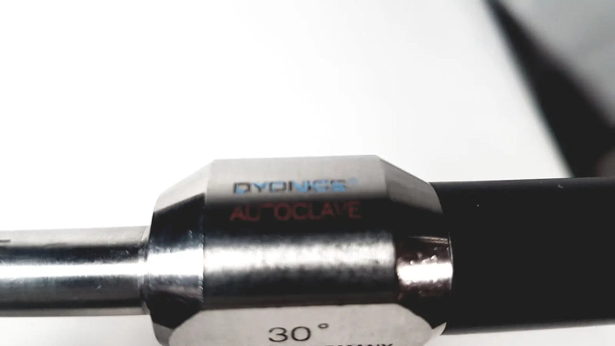Silver metallic alloy angle gauge with dyonics autoclave ref branding and 30 degree marking for dyonics autoclave use