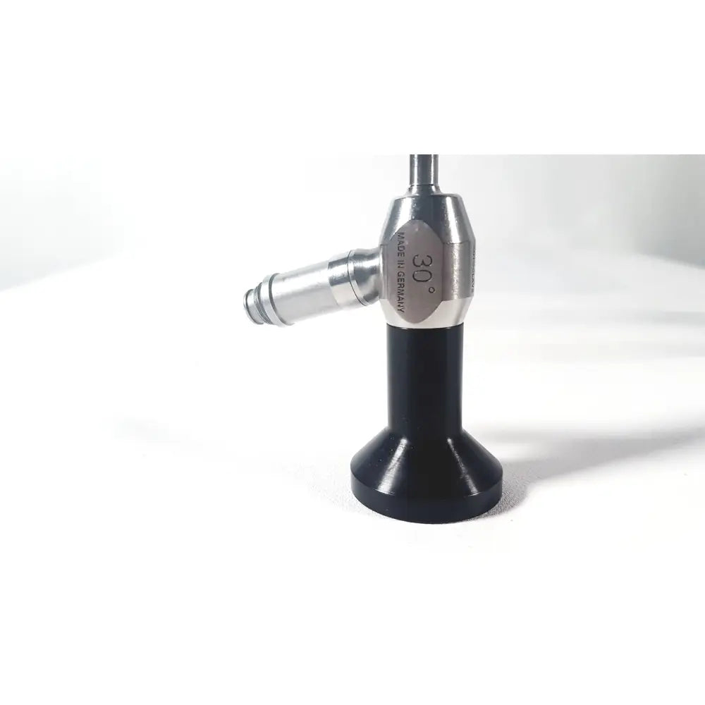 Dyonics autoclave ref 7207952 30 degree laparoscope with a sleek silver body and black base for surgical use