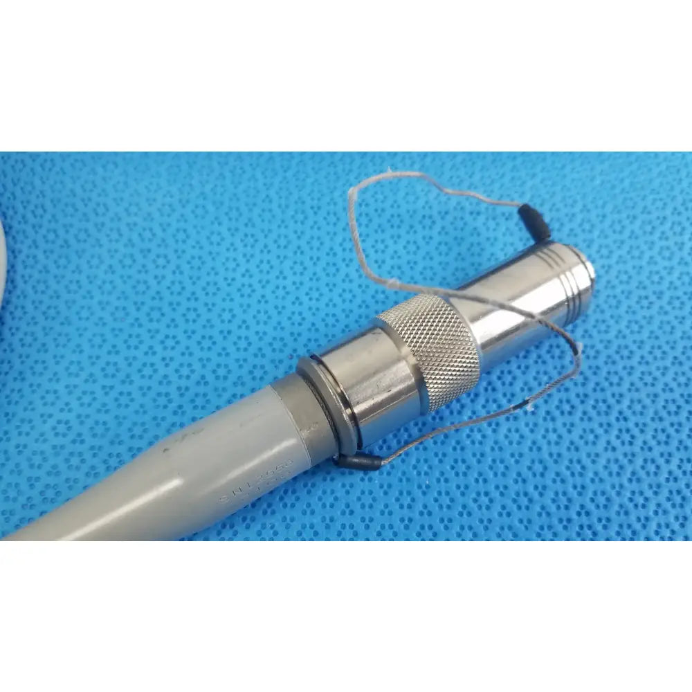 Dyonics powermax elite shaver handpiece featuring a silver metallic textured grip and gray plastic handle medical equipment