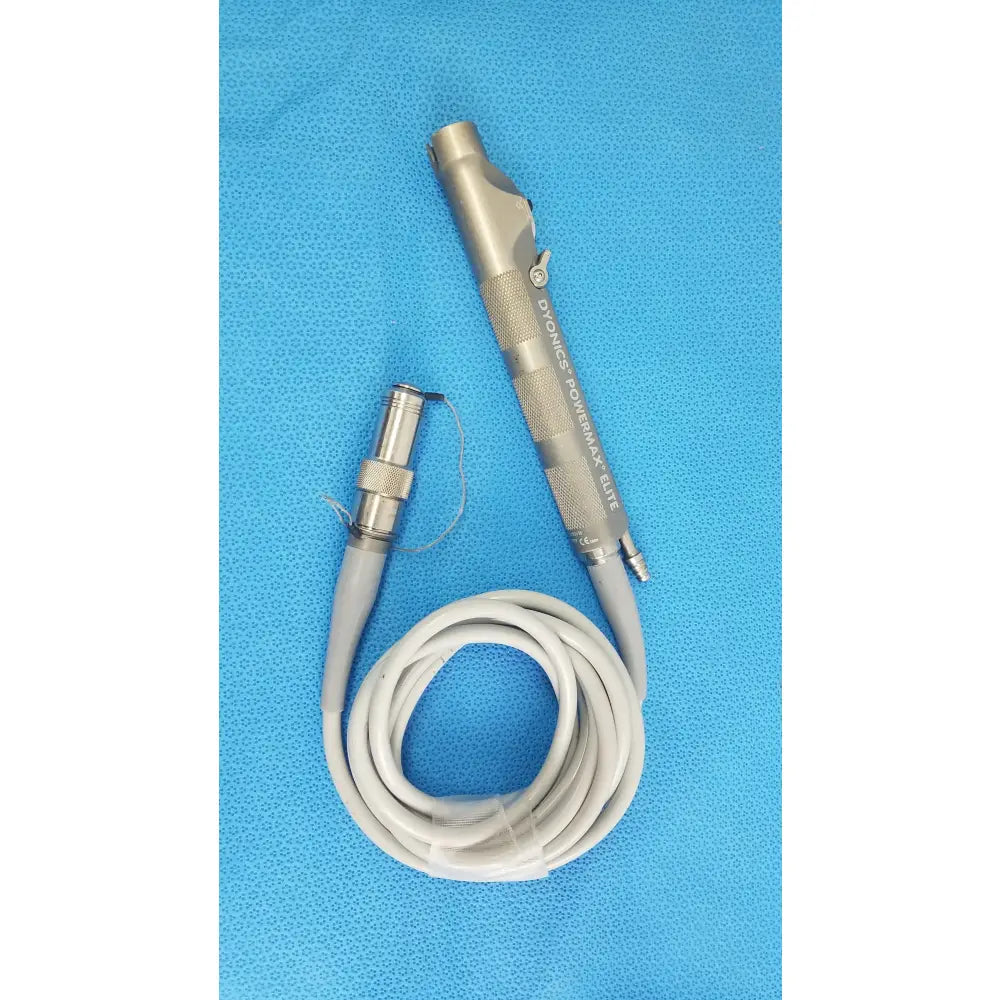Silver metallic dyonics powermax elite shaver handpiece with textured grip and coiled gray cable for medical equipment use