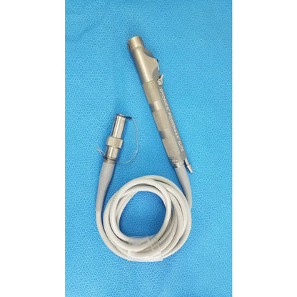 Silver metallic dyonics powermax elite shaver handpiece with textured grip and coiled gray cable for medical equipment use