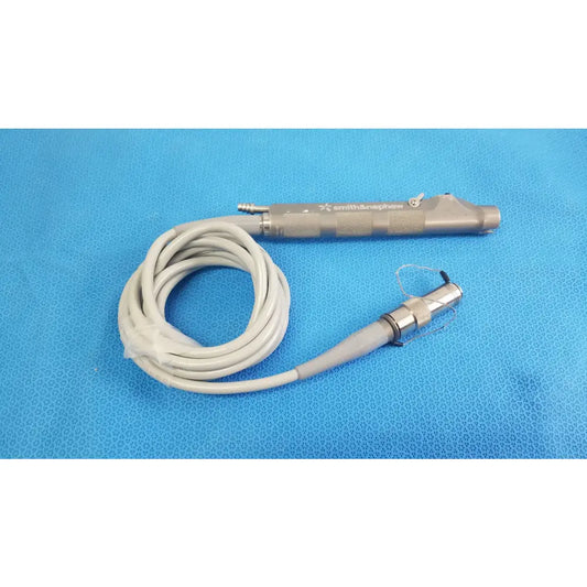 Smith & nephew dyonics powermax elite shaver handpiece with metallic gray handle and coiled white cable medical equipment