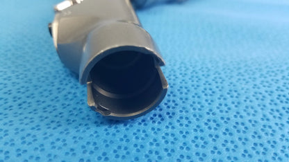 Gray metallic cylindrical powermax elite shaver handpiece connector with hollow interior and visible mechanical fittings for medical equipment