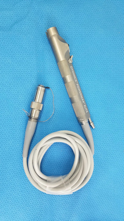 Silver metallic dyonics powermax elite shaver handpiece with textured grip and coiled gray cable for medical equipment use