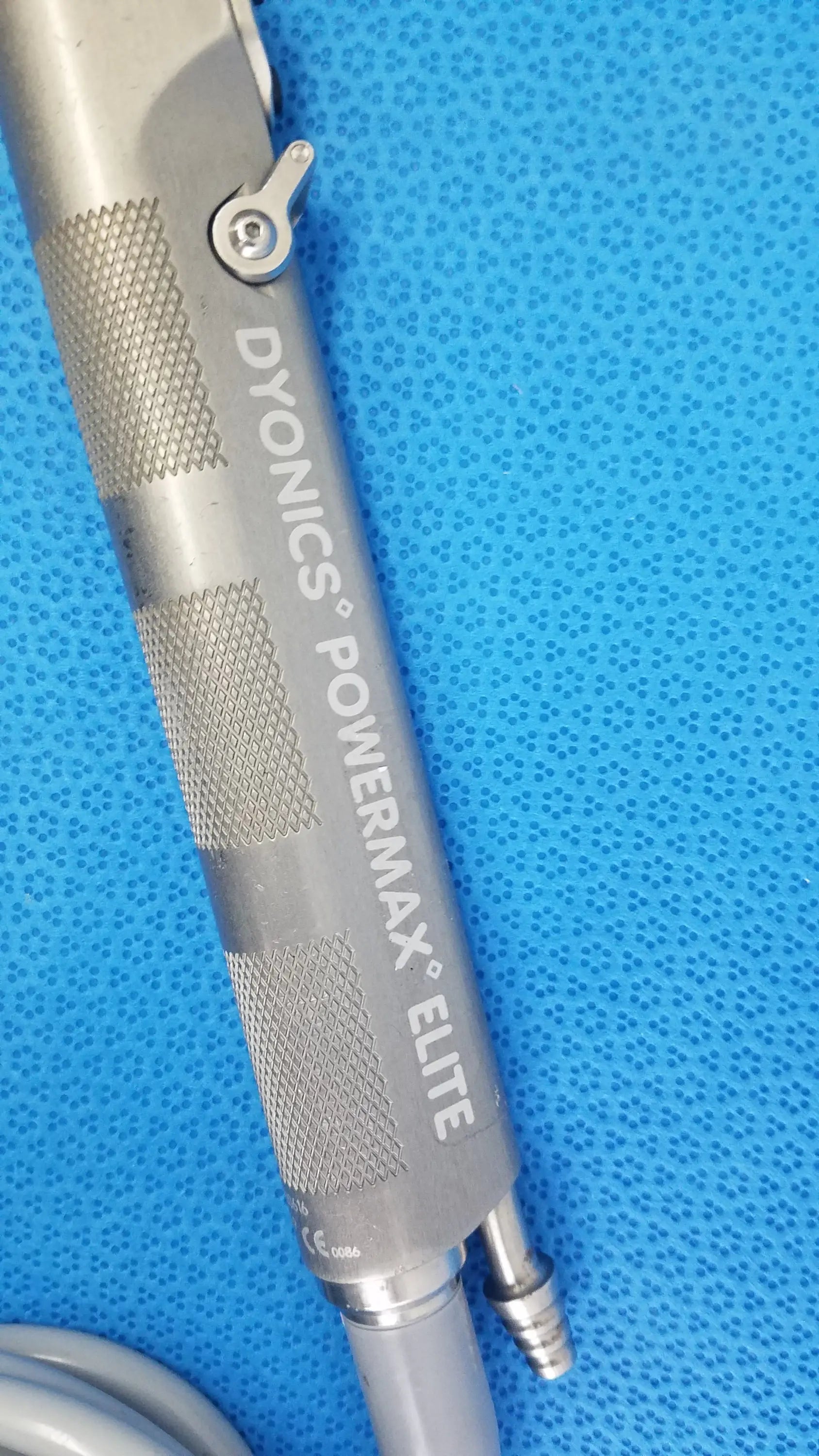Silver metallic powermax elite shaver handpiece with textured grip and adjustment knob for medical equipment use