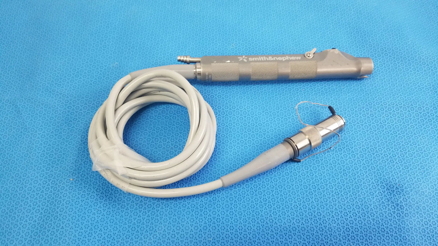 Smith & nephew dyonics powermax elite shaver handpiece with metallic gray handle and coiled white cable medical equipment