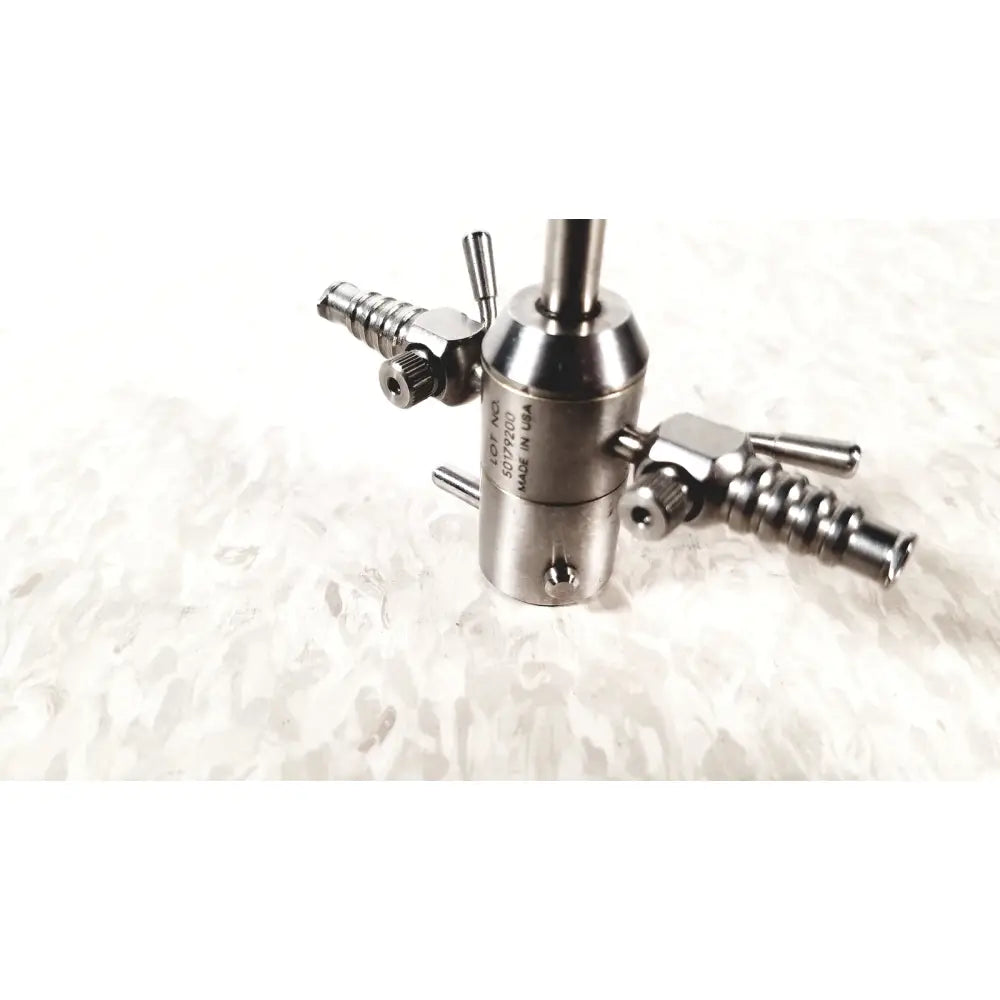Silver metallic surgical gas valve with threaded ports and engraved markings for dyonics sheath rotatable ref 3869