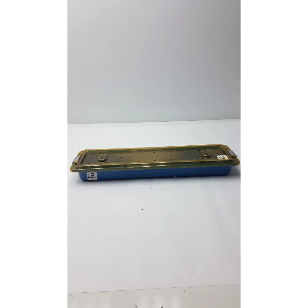 Blue dyonics video sterilization soaking tray with gold metal lid featuring holes and two latches soaking tray case