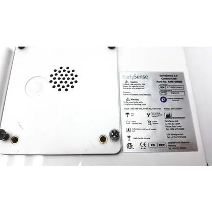 White plastic earlysence 2.0 control unit with black speaker grille and gold screw holes for reuse medical applications