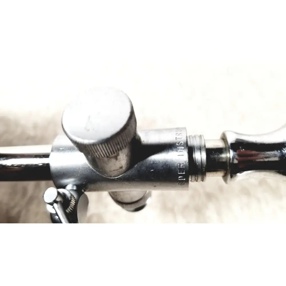 Silver metallic eder instrument cat medical instrument with engraved text and knurled adjustment knob for endoscope use