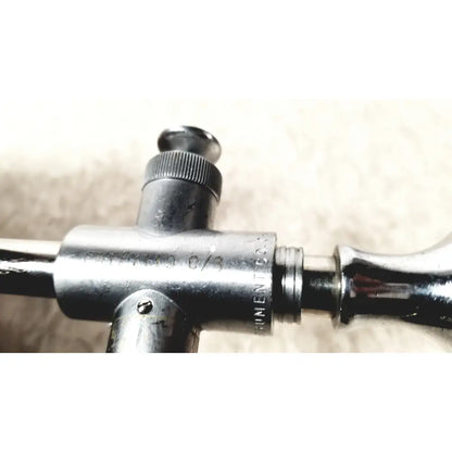 Silver-colored metal eder instrument cat surgical instrument with engraved markings and textured knob for endoscope use