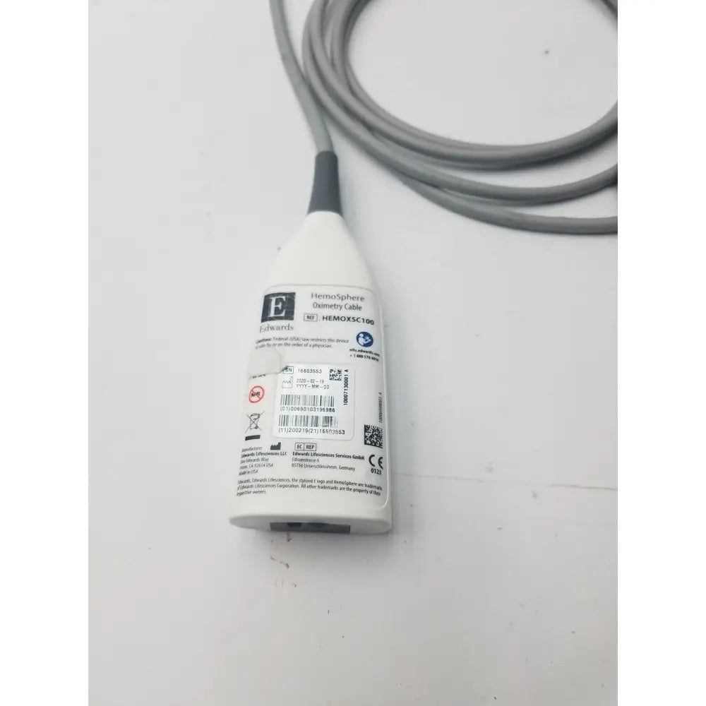 White plastic edwards hemosphere oximetry cable with gray coiled cord and black connector for medical use