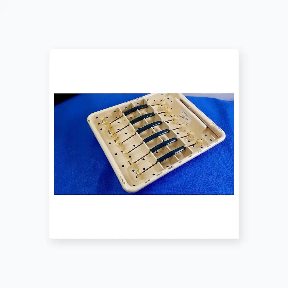 White plastic surgical tray holding six blue-handled dental instruments with glass tips for buy used medical equipment
