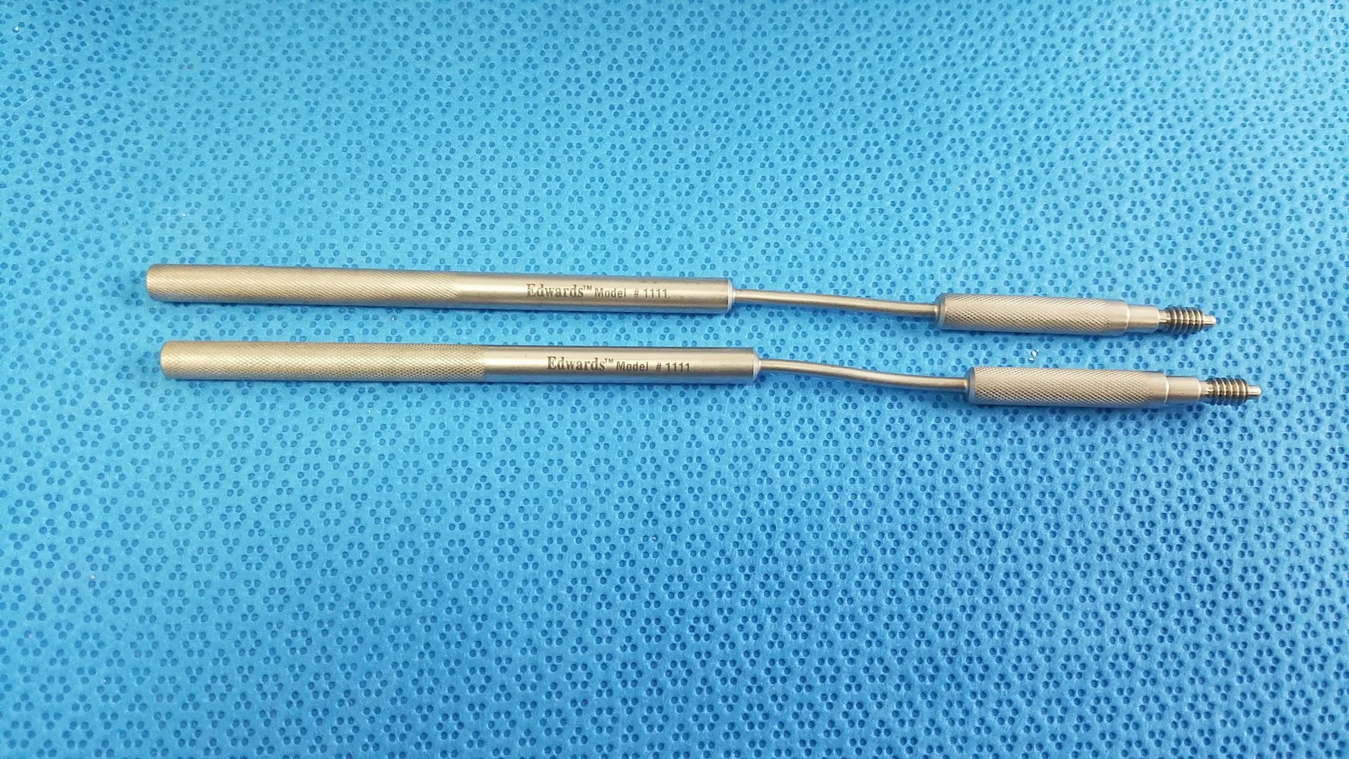 Two metallic edwards life science 1111 perimount magnas ease aortic valve sizers with textured handles on blue surface for buy used medical equipment