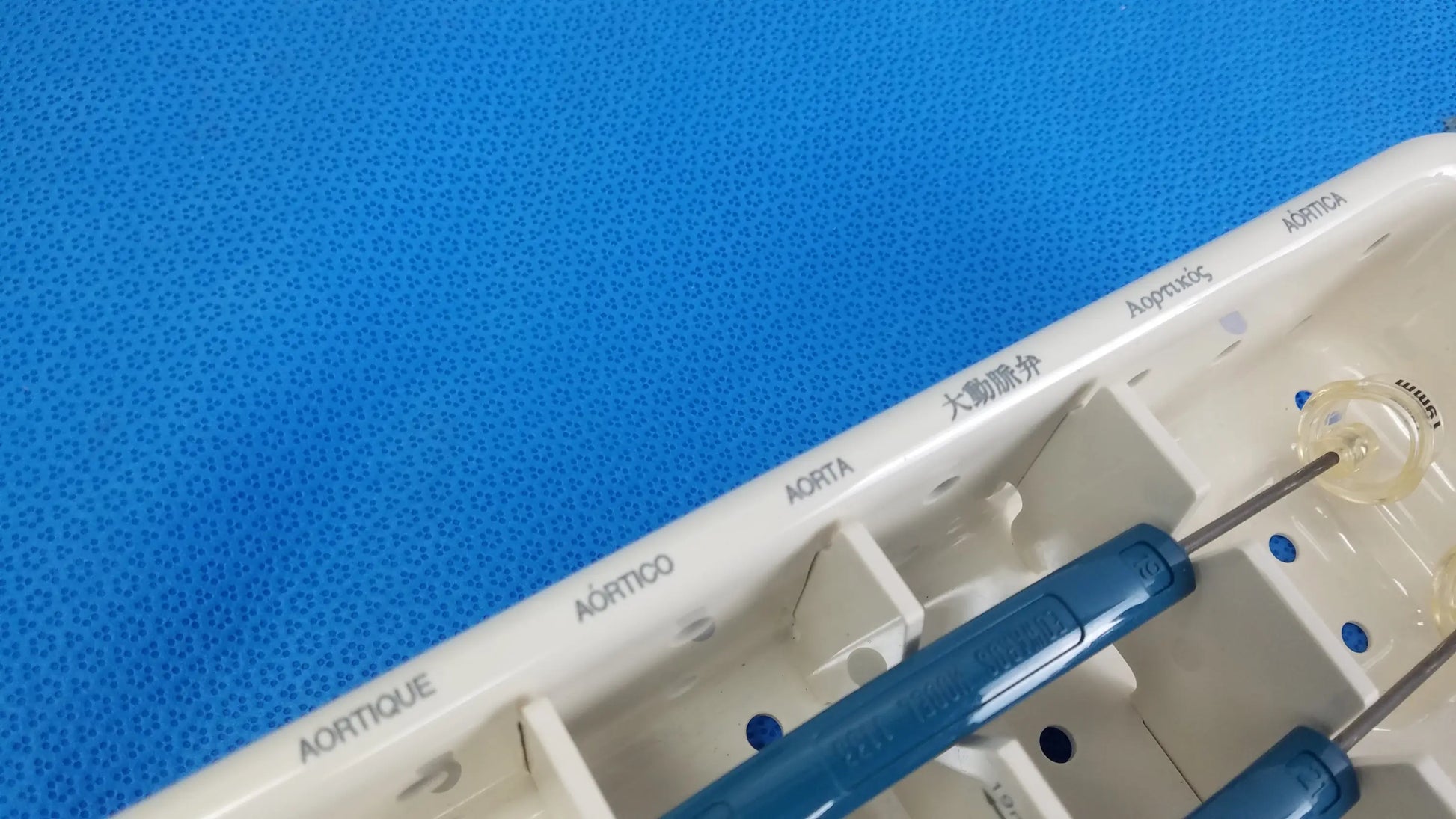 Beige plastic surgical instrument tray with blue-handled tools and labeled compartments for aortic valve sizing in edwards life science 1111 perimount magnas ease aortic valve sizer set for buy used medical equipment