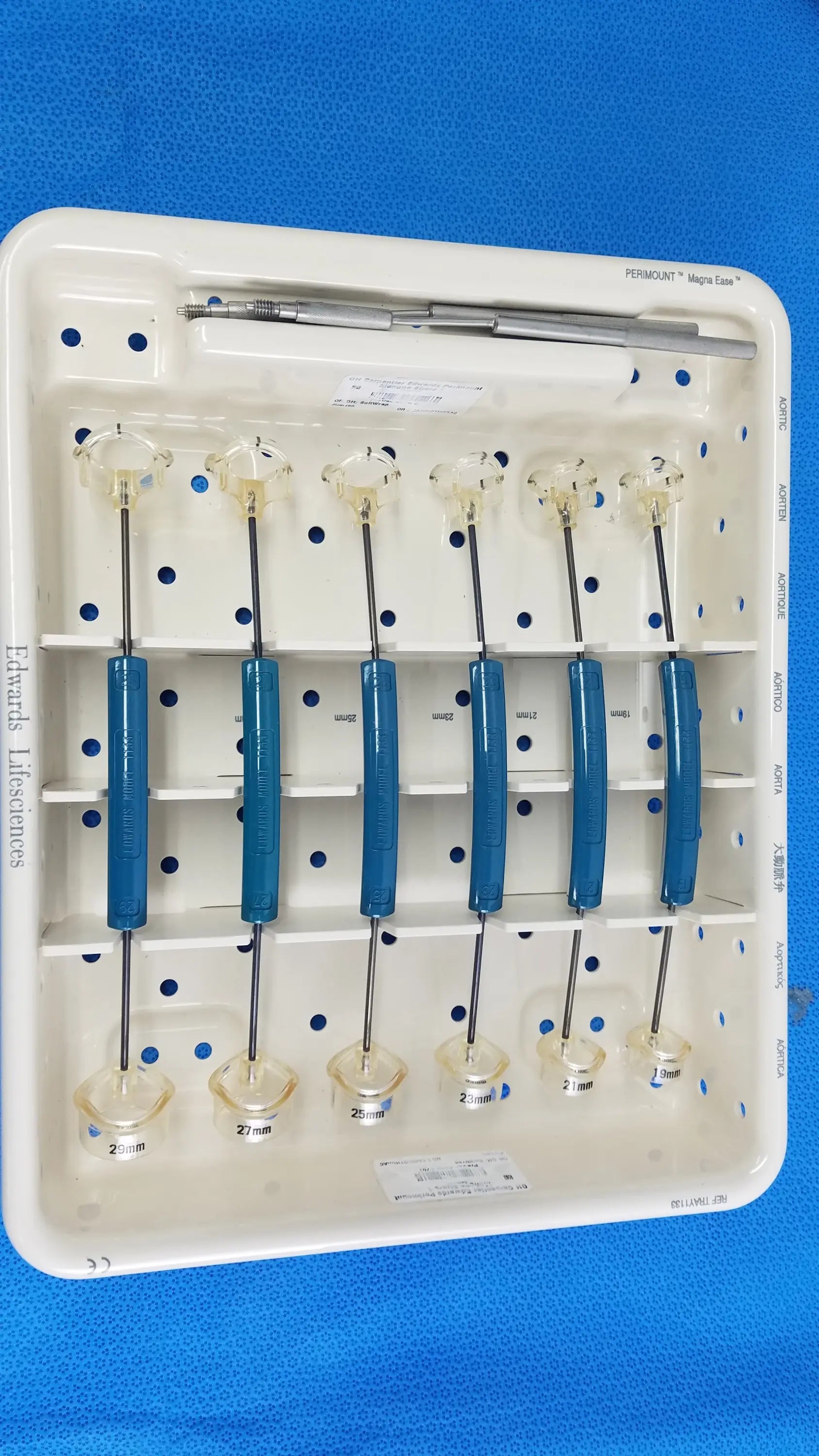 White plastic tray holding six blue-handled edwards life science 1111 perimount aortic valve sizers for buy used medical equipment