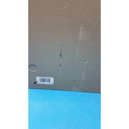 Gray plastic box bottom of electrical control panel with white barcode label and minor scratches showing timer relay use