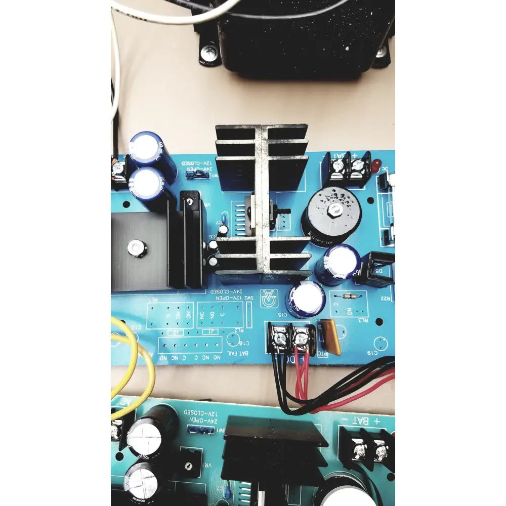 Blue printed circuit board electrical control panel with time delay relay black heat sinks and silver capacitors