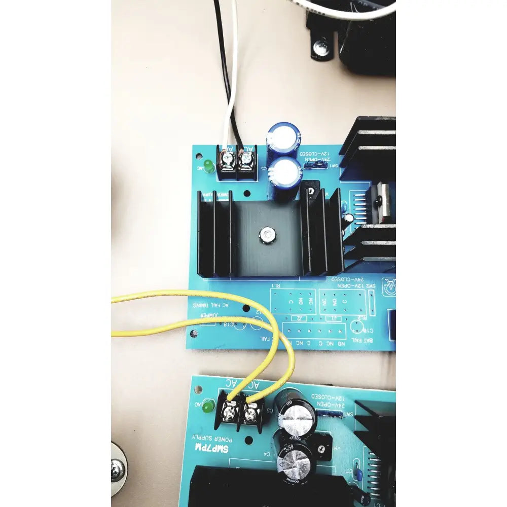 Blue printed circuit board electrical control panel with black heat sinks silver capacitors and time delay relay