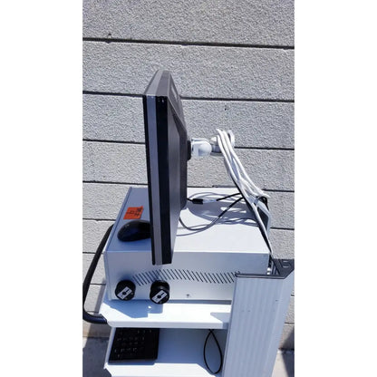 Black ellex eyecubed ultrasound biomicroscopy system monitor mounted on white cart with keyboard and two black knobs