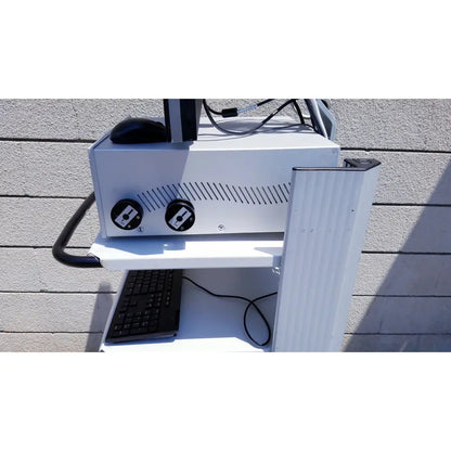 White metal cart with black keyboard and dual circular control knobs for ellex eyecubed ultrasound biomicroscopy system stand extras as-is