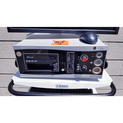 Silver and black professional audio mixing console with multiple ports and cd player shown with ellex eyecubed ultrasound biomicroscopy system