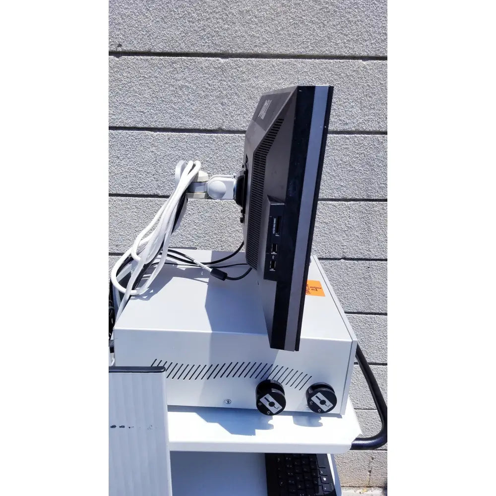 Black monitor with silver trim mounted on white stand of ellex eyecubed ultrasound biomicroscopy system as-is